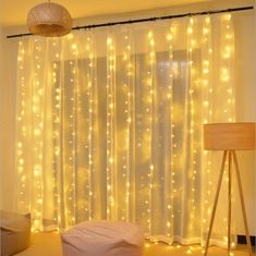 a room with lights on the curtains and a bean bag chair in front of it