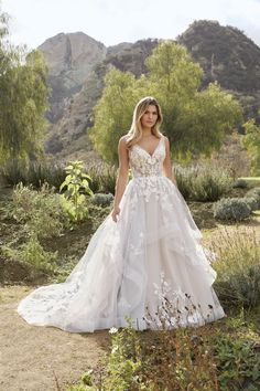 a woman wearing a wedding dress in the desert