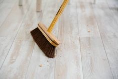 a broom is laying on the wooden floor