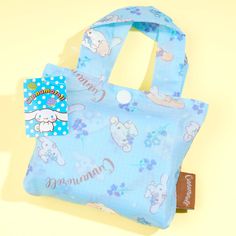 This kawaii eco bag is decorated with super cute illustrations of Cinnamoroll and his besties harvesting lots of blue flowers! Bring this foldable tote with you whenever you go out shopping at the nearby mall. Made from polyester Kawaii Blue Rectangular Bag, Kawaii Light Blue Bags For Everyday Use, Kawaii Light Blue Bag For Everyday Use, Light Blue Kawaii Bag For Everyday Use, Light Blue Kawaii Bag For Everyday, Blue Foldable Tote Bag, Kawaii Blue Bag For Daily Use, Cute Reusable Travel Bags, Cute Light Blue Bag For Gift