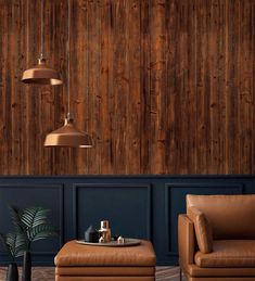 a living room with two leather chairs and a footstool in front of a wood paneled wall