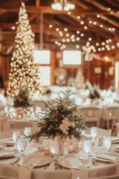 the tables are set with white table cloths and place settings for an elegant winter wedding