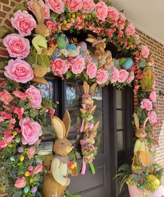 the front door is decorated with flowers and bunnies