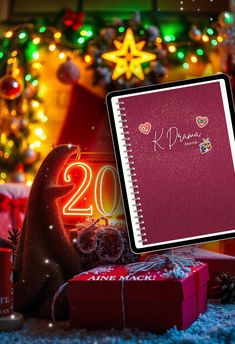 a red notebook sitting on top of a pile of presents