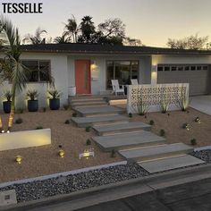 a house with steps leading up to the front door and landscaping in front of it