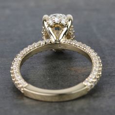 a yellow gold engagement ring with diamonds on it