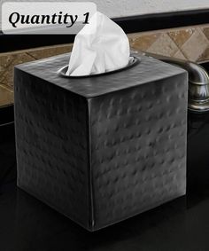 a tissue dispenser sitting on top of a counter