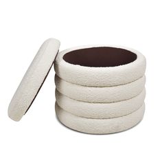 a stack of white round pads with brown linings on each side and an open one in the middle