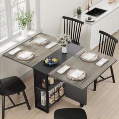 a kitchen table with chairs and plates on it