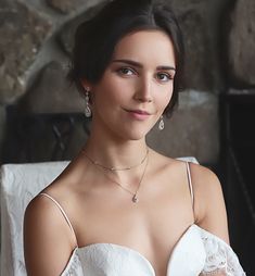 a woman in a white dress posing for a photo