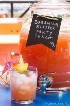 there is a pitcher of orange juice with a sign that says batman blaster party punch