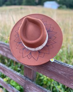 Stay stylish and sun-safe with the In Full Bloom Rancher Hat. Crafted with a full brim design, this chic hat features a beautiful hand burned sunflower, perfect for those who favor boho looks. Brown Curved Brim Sun Hat For Festivals, Brown Curved Brim Festival Sun Hat, Festival Brown Curved Brim Sun Hat, Bohemian Brown Hat One Size, Bohemian Brown Hat One Size Fits Most, Brown Brimmed Hippie Hat, Brown Hippie Brimmed Hat, Hippie Brown Hat With Short Brim, Brown Wide Brim Hippie Hat