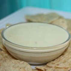 some tortilla chips and dip in a bowl