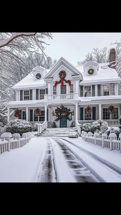 a large white house covered in snow with wreaths