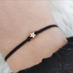 Minimalist friendship/wish bracelet with a tiny gold-plated steel star charm, pavé with CZ crystals (cubic zirconia). A lovely gift for every occasion! ------------------------------------------------------ D E T A I L S: Star size: 5mmx5mm /approx. 0.2''x0.2'' The star is made from steel and is set with 6 CZ crystals Double 1mm nylon cord >  15 colors to choose from *Please allow small color differences from the ones you see on the photos. Tie/knot closure for adjustable length > Please read th Adjustable Yellow Gold Star Bracelet, Adjustable Minimalist Star Jewelry, Adjustable Dainty Star Jewelry, Adjustable Everyday Bracelet With Star Charm, Adjustable Everyday Bracelets With Star Charm, Adjustable Star Charm Bracelet For Everyday, Minimalist Adjustable Star Charm Jewelry, Adjustable Star-shaped Minimalist Bracelet, Star Friendship Bracelet