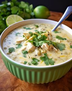 a green bowl filled with soup and garnished with cilantro