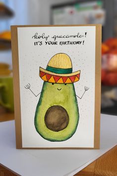 an avocado with a sombrero on it's head, says happy guacamole it's your birthday