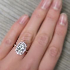 a woman's hand with a diamond ring on it