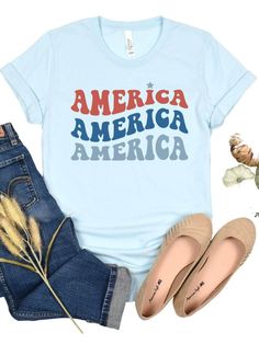 Looking for the perfect way to show off your love for America? Look no further than our America America America Patriotic T-shirt! Featuring a bold retro font in red and blue, this shirt is sure to make a statement. Made from high-quality Bella + Canvas cotton blend fabric, this shirt is both comfortable and durable. Available in six different colors, you can choose the perfect shade to suit your personal style. And with sizes ranging from XS to XXXL, this shirt is sure to fit everyone. Each shi Retro Font, Made In America, Show Off, In America, Jersey Shorts, Suits You, Women Collection, Fabric Care, Bella Canvas