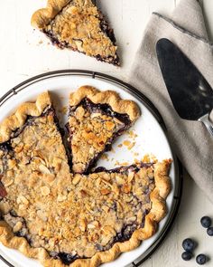 blueberry pie with one slice cut out on a plate