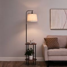 a living room with a couch, lamp and painting on the wall