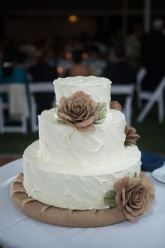 a white wedding cake sitting on top of a table