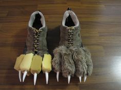 two pairs of shoes with spikes on them sitting on a wooden floor next to each other