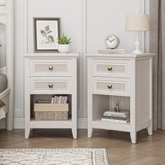 two white nightstands sitting next to each other in a bedroom