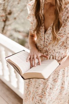 a woman holding an open book in her hands