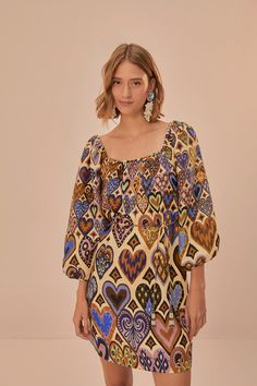 Embrace a tapestry of affection with the Cream Hearts Ikat Long Sleeve Mini Dress. Adorned with a playful ikat-inspired heart pattern in warm earth tones and vivid blues, this piece celebrates love with a bohemian twist. The billowing long sleeves and captivating square neckline accentuate its charming silhouette, while the soft cream canvas becomes a backdrop for moments of joy and whimsy. An ode to free-spirited style, this dress is a treasure for any wardrobe. Composition 100% LINENCare Instructions MACHINE WASH, GENTLE CYCLE, DO NOT BLEACH, DO NOT TUMBLE DRY, LINE DRYING, IRON AT LOW HEAT, DO NOT DRY CLEANSize and Fit Inches XXS XS S M L XL Bust 38 2/4 40 2/4 42 2/4 44 2/4 47 3/4 50 3/4 Waist N/A N/A N/A N/A N/A N/A Length 28 1/4 28 3/4 29 2/4 30 1/4 30 3/4 31 2/4 Hip 42 2/4 44 2/4 46 Bohemian Twist, Ikat Dress, Maxi Romper, Free Spirit Style, The Cream, Heart Pattern, Farm Rio, Long Sleeve Mini, Heart Patterns