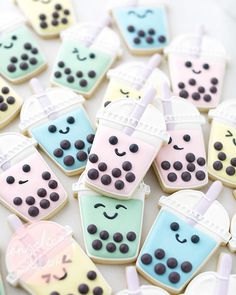 decorated cookies in the shape of drinks and ice creams are arranged on a table