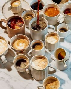 there are many cups of coffee on the table