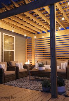 an outdoor living area is lit up with string lights