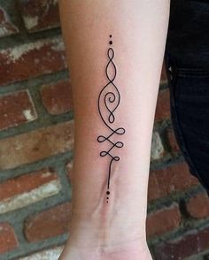 a woman's arm with a small tattoo on the wrist and an arrow in the middle