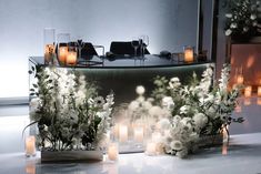 flowers and candles are arranged on a table