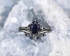 a close up of a ring on top of some rocks with crystals in the background