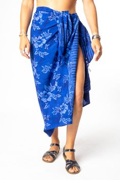 Set your watch to island time and embrace the artistic origins of our tasseled sarong wraps. Dyed with the traditional Indonesian batik method, the colors on this batik sarong are bright and vibrant, and the patterns are uniquely boho chic! From its traditional South Pacific use as a woman's or man's wrap skirt to a hippie skirt, a wall hanging, turban, tablecloth or window dressing, you will never run out of options with a beautiful batik sarong! All Mexicali Blues batik items are handmade in B Bohemian Batik Print Sarong For Festival, Bohemian Sarong With Tropical Print For Beach Season, Traditional Batik Print Sarong For Vacation, Bohemian Style Sarong With Tropical Print For Beach Cover-up, Bohemian Tropical Print Sarong For Beach Cover-up, Bohemian Batik Print Sarong For Vacation, Bohemian Batik Print Sarong For Summer, Summer Bohemian Batik Print Sarong, Bohemian Batik Print Sarong For Beach Season