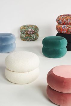 several different types of round cushions on a white surface