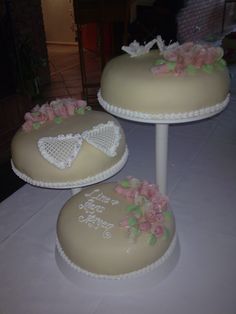 two wedding cakes sitting on top of a table