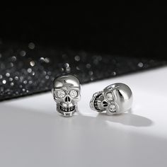 "We love the night. It's the only time I feel really alive." A striking set of earrings crafted in brilliant sterling silver inlaid with clear white stones. So cool, so unique. A unique statement piece that is great for everyday casual wear. It is also suitable to wear for Halloween to highlight your personality.Carat Weight: 0.1 ctStone Size: 1.8 mmStone Type: Jeulia® StoneNumber of Stones: 4 Stone Shape: RoundStone Color: Fancy BlackWeight: 3.43 gWidth: 7.3 mmHeight: 10.8 mmThickness: 5.2 mmMa Silver Skull Earrings For Pierced Ears, Silver Earrings With Diamond Eyes For Anniversary, White Sterling Silver Skull Jewelry, White Skull-shaped Sterling Silver Jewelry, Sterling Silver Skull Earrings For Gift, Silver Skull Earrings, Skeleton Knight, White Stones, Sterling Silver Stud Earrings