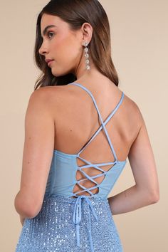 Your dazzling presence will be seen from any angle on the dance floor with a look like the Lulus Bold Aesthetic Blue Sequin Lace-Up Bodycon Mini Dress! Shimmering blue sequins decorate a mesh overlay (atop a matching knit liner) that shapes a sleeveless bodice with sheer mesh paneling at the back and supportive boning, a straight neckline, and slender straps that create a trendy lace-up design. The fitted waist tops a sexy bodycon skirt that ends at a flirty, notched mini hem. Hidden back zipper Blue Evening Dress With Corset Back For Gala, Blue Evening Dress With Corset Back And Fitted Bodice, Blue Evening Dress With Sweetheart Neckline And Corset Back, Blue Evening Dress With Corset Back, Glamorous Light Blue Fitted Evening Dress, Glamorous Fitted Light Blue Evening Dress, Blue Evening Dress With Boned Bodice For Prom, Blue Dress With Corset Back For Gala, Blue Prom Evening Dress With Corset Back