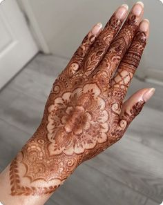 a woman's hand with hennap on it, showing the intricate design