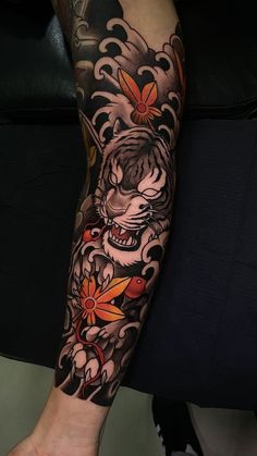 a person with a tiger tattoo on their arm