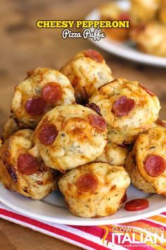 mini pizzas are piled on a plate with pepperoni and cheese in the middle