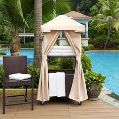 an outdoor gazebo next to a pool with towels on it and a chair in the foreground