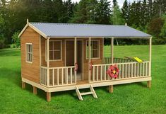 a small wooden cabin sitting on top of a lush green field