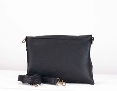 "The Erato oversized clutch, cross body purse in Black soft Italian leather. This leather bag is perfect for either a walk during the day using the long adjustable strap or grab it in your hand on a night out.Both practical and stylish.The flap secures with a hidden magnet.On the outside there is a zippered pocket measuring 4.5\" (11.5cm) x 4\" (10cm) at its lowest edge(it fits an iphone nicely). Inside the bag you 'll find a lining made out of a grey cotton fabric .There is a zippered pocket me Office Clutch With Adjustable Strap, Crossover Purse, Oversized Clutch, Large Clutch, Cross Body Purse, Black Leather Purse, Envelope Clutch, Purse Clutch, Grey Cotton