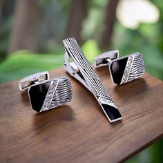 This tie bar and cuff-links set has a unique zebra looking pattern with small stones on the edges. There is enough detail to stand out but not too much that it overtakes your tie design! This makes a great gift for someone who appreciate details. Material of Cuff-links: Zinc Alloy Dimensions of Cuff-links: 1.5” Inches x 1.5” Inches. Color and Shape Of Tie Bar and Cuff-links: Black, Chrome with Zebra and Stones Choose From: Tie Bar and Cuff-links Tie Bar Only Cuff-links Only Luxury Screw Back Cufflinks For Wedding, Elegant Clip-on Cufflinks For Formal Wear, Elegant Clip-on Cufflinks For Formal Occasions, Elegant Formal Clip-on Cufflinks, Luxury Screw Back Cufflinks, Tie Design, Cufflink Set, Tie Bar, Tie Clip