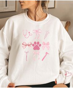 Are you looking for a fun gift for your favorite animal person? Check out this sweatshirt! It has a fun heart and paw design on the sleeve. Order yours today! Ideal for any situation, a unisex heavy blend crewneck sweatshirt is pure comfort. These garments are made from polyester and cotton. This combination helps designs come out looking fresh and beautiful. The collar is ribbed knit, so it retains its shape even after washing. There are no itchy side seams on these sweaters.  .: Made with a medium-heavy fabric blend of 50% cotton and 50% polyester (8.0 oz/yd² (271.25 g/m this sweatshirt feels cozy and is the perfect choice for those colder months. .: The classic fit along with the crew neckline deliver a comfy wearing experience with a clean-cut style. Meanwhile, the double-needle stitch Vet Scrubs, Vet Tech Shirt, Vet Tech Gifts, Vet Assistant, Vet School, Vet Med, Tech Gift, Paw Design, Tech Shirt