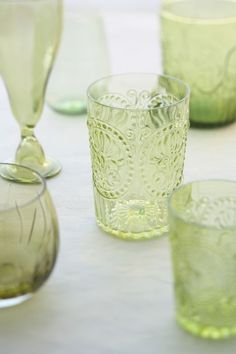 green glassware sitting on top of a white table